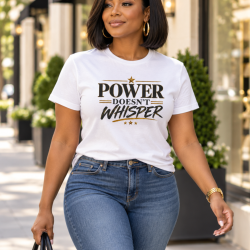 Power Doesn’t Whisper T-Shirt in white with bold black and gold typography, modeled by a woman walking outdoors.
